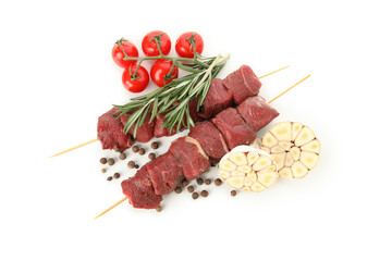 Skewers with raw meat and vegetables isolated on white background
