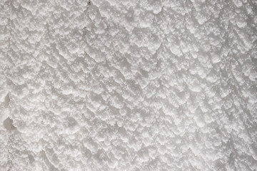 White embossed walls of ice and snow in a cave. Abstract textured natural background.