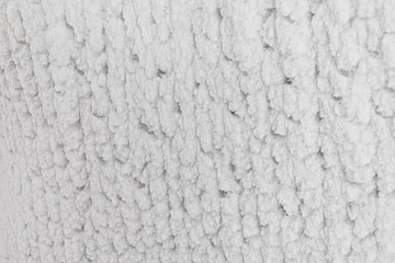 White embossed walls of ice and snow in a cave. Abstract textured natural background.