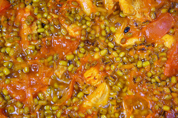 Mung beans cooking with Turkey and tomatoes. close-up