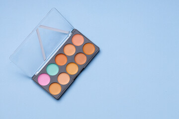 Set of eyeshadows on blue background close up