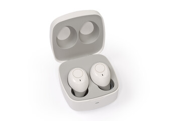 White wireless earphones in wireless charging case on white background