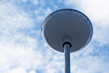 large round and white street lamp against summer sky