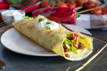 spicy pancake with minced meat stuffing on a white plate