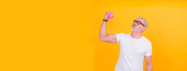 Portrait of senior man exercising with dumbbells