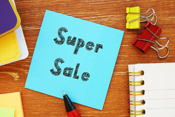 Financial concept about Super Sale with phrase on the piece of paper.