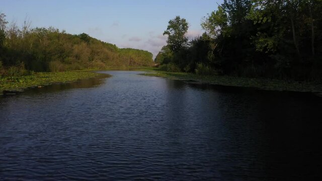 A video shot at sunset between the long trees with a drone in Sakarya Karasu Lake which is in Turkey. It is a real natural beauty.