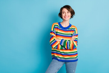 Photo portrait of confident woman with folded arms looking at blank space isolated on pastel blue colored background