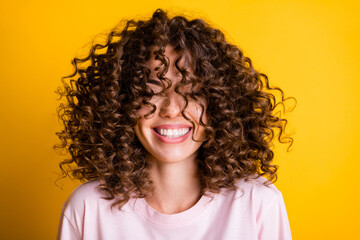 Headshot of laughing cheerful girl with curly hairstyle wearing t-shirt white toothy smile isolated...