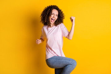 Photo portrait of woman celebrating isolated on vivid yellow colored background