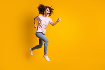 Photo portrait full body view of screaming woman jumping up running isolated on vivid yellow colored background