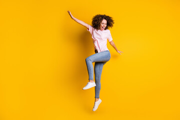 Fototapeta na wymiar Photo portrait full body view of happy girl dancing jumping up isolated on vivid yellow colored background