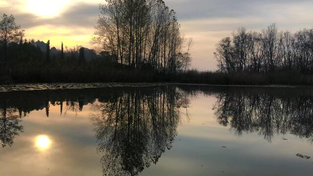 A video shot at sunset between the long trees with a drone in Sakarya Karasu Lake which is in Turkey. It is a real natural beauty. 