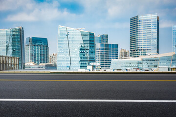 empty road with zebra crossing and skyscrapers in modern city