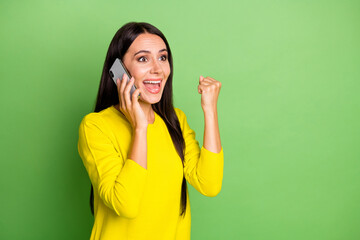 Profile photo of delighted person speak phone fist up open mouth celebrate isolated on green color background