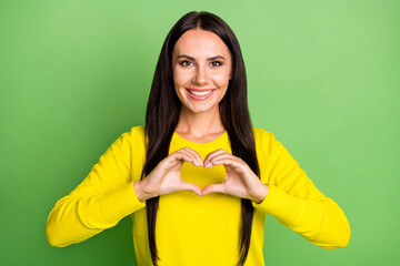 Portrait of adorable girl fingers showing heart symbol wear pullover isolated on green color background