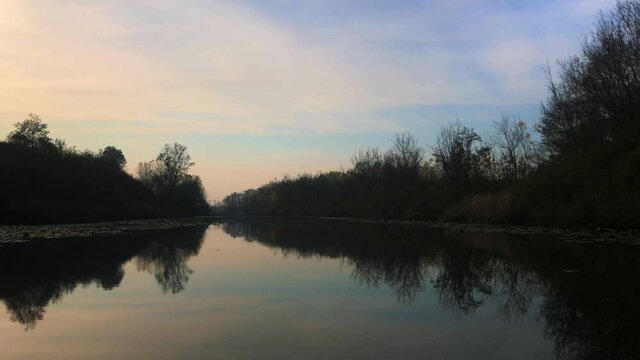 A video shot at sunset between the long trees with a drone in Sakarya Karasu Lake which is in Turkey. It is a real natural beauty.
