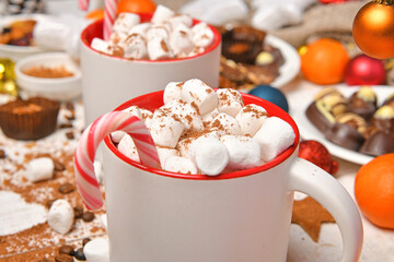 sweet food top view background for merry christmas or new year holiday decoration - chocolate candies, tangerines, cookies, marshmallow and cocoa latte on white wood
