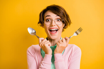 Photo of funky excited lady hold spoon fork open mouth wear glasses teal shirt pink cardigan...