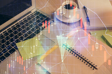 Multi exposure of forex graph drawing and desktop with coffee and items on table background. Concept of financial market trading