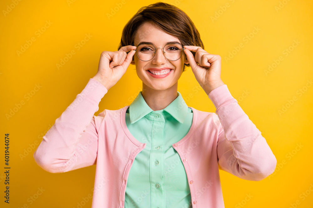 Wall mural photo of cheerful young girl hold spectacles wear eyeglasses turquoise shirt pink cardigan isolated 