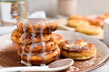 Sweet cottage cheese pancakes. Condensed milk. Festive sweet breakfast or lunch. Light background. Close up
