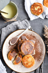 Sweet cottage cheese pancakes. Condensed milk. Festive sweet breakfast or lunch. Grey background. Top view