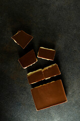 Top view of dark milky chocolate on the grey table.Vertical image