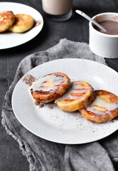 Sweet cottage cheese pancakes. Condensed milk. Festive sweet breakfast or lunch. Dark grey background. Vertical view