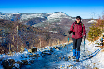 Mature woman on a mountain trip. Healthy and active lifestyle of older people.