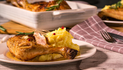 Italian pan braised  rosmary chicken with mashed potatoes  served on a white plate. Pollo in padella