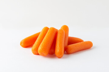Small peeled pieces of carrot on white background