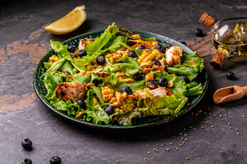 Fresh Tasty blueberries salad with chicken fillet, green vegetables and mustard. healthy food. banner, catering menu recipe place for text, top view