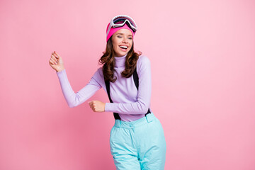 Photo of sweet charming lady snowboarder wear purple pullover headwear mask glasses dancing isolated pink color background