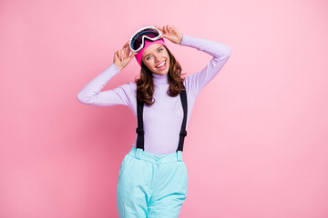 Photo of charming sweet woman skier dressed violet sweater arms goggles mask having rest isolated pink color background