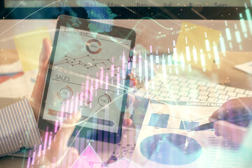 Multi exposure of man's hands holding and using a phone and financial chart drawing. Market analysis concept.