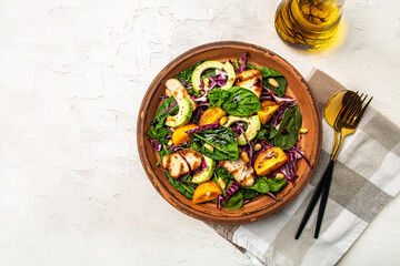Ketogenic, paleo diet breakfast. Purple cabbage, avocado, spinach, tomatoes, fillets and nuts. Delicious breakfast or snack on a light background, top view.
