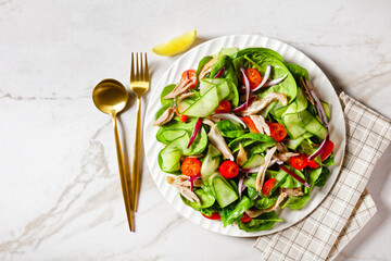 Chicken and spinach salad on a table, free space