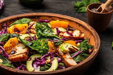 Ketogenic, paleo diet breakfast. Purple cabbage, avocado, spinach, tomatoes, fillets and nuts. Delicious breakfast or snack on a light background, top view.