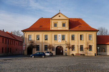 Baroque house of Manorial pub on main King Vladislav Square in old historic center of medieval city Velvary in sunny day, Central Bohemia, Czech Republic
