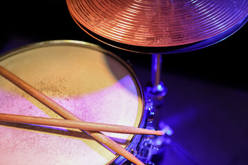 Drum sticks on a snare drum close up top view.