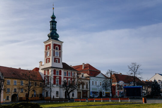 Old Town Hall with Clock Tower at the main Masaryk square of historic medieval royal town Slany, colorful renaissance houses in sunny winter day, Central Bohemia, Czech Republic