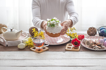 Homemade Easter cake on a festive table among flowers and decor details.