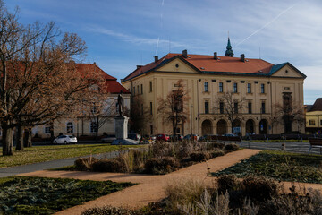 Statue of Tomas Garrigue Masaryk at the main square of historic medieval royal town Slany, Piarist dormitory now Homeland Museum and library in sunny day, Bohemia, Czech Republic