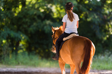 Young  girl riding a horse