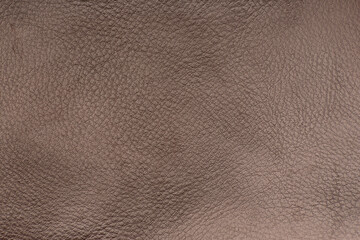 Brown smooth leather surface. Texture background. Close-up.