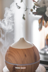 Fototapeta na wymiar Modern oil aroma diffuser close up on a blurred background.
