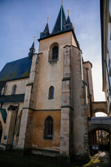 Gothic church of Saint Gothard with bell towers in old historic center of medieval royal town Slany in sunny winter day, Central Bohemia, Czech Republic