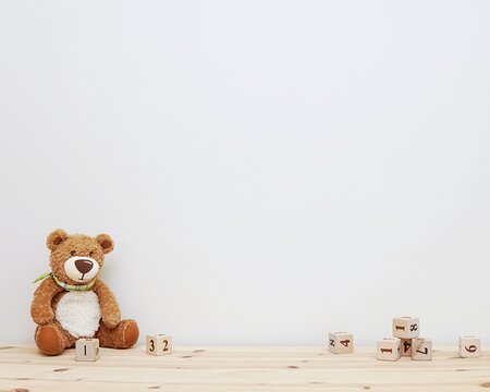 Naklejka Empty nursery wall mockup, soft toy and wooden cubes, space for baby room wall decal, stickers or framed art presentation.