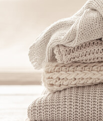 A stack of neatly folded warm knitwear, wool close up.